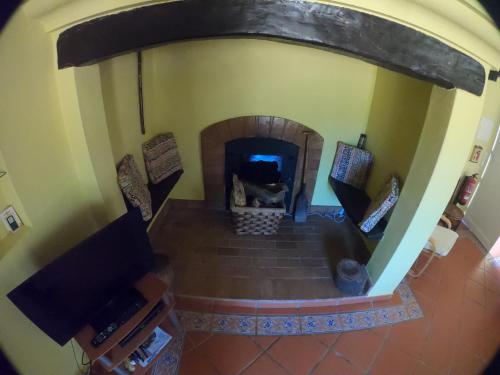 an overhead view of a living room with a fireplace at Country House Porto Covo, Monte da Casa Velha in Santiago do Cacém