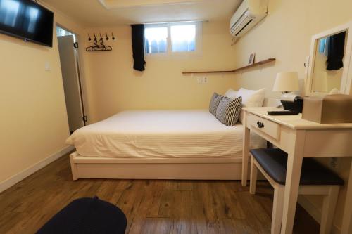 A bed or beds in a room at Just4u Guesthouse