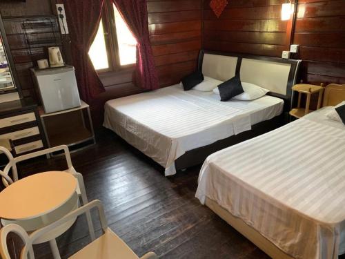 Ένα ή περισσότερα κρεβάτια σε δωμάτιο στο Nipah Bay Villa