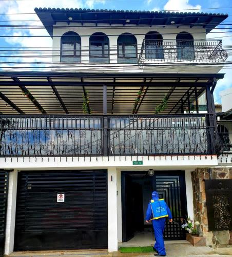 a man in a blue jacket standing outside of a building at Air Suites Hotel Boutique in Quito