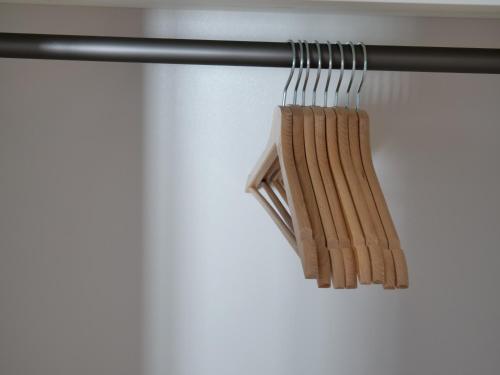 a bunch of wooden chopsticks hanging from a rail at Apartments Sabine K in Merano