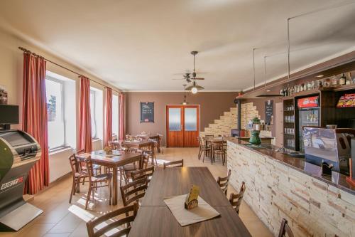 a restaurant with tables and chairs and a bar at Na Rybníčku Bohutín in Bohutín