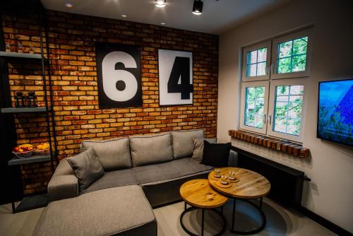 a living room with a couch and a table at Apartament Piastowska No.6 in Olsztyn