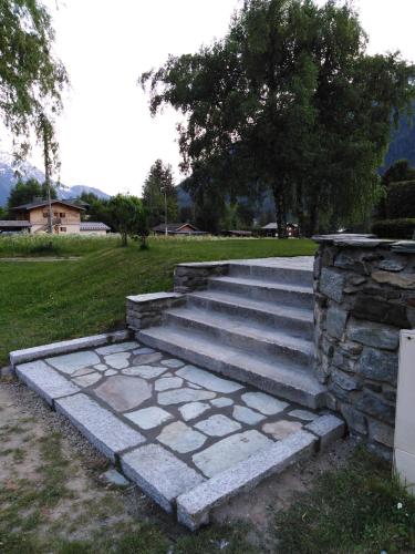 a set of concrete steps with a stone wall at Appartement avec Terrasse in Chamonix-Mont-Blanc