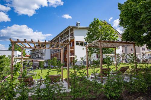 a building with a garden in front of it at Hotel St. Florian in Frauenau