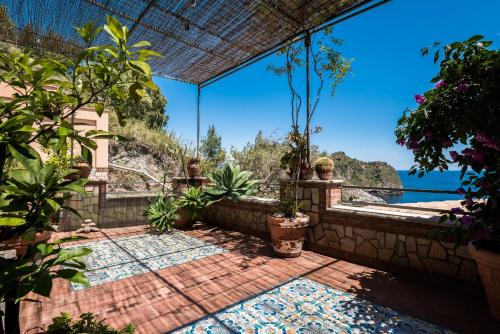 an outdoor patio with a view of the water at 202 luxury terrace view in Taormina