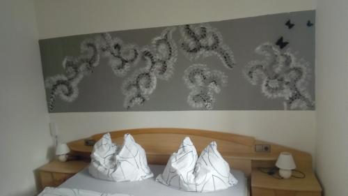 a bedroom with a bed with a painting on the wall at Landhaus Tirol in Presseggersee