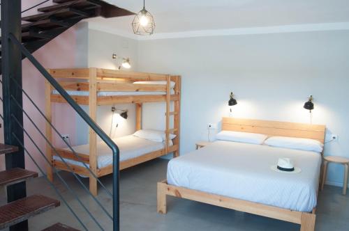 a bedroom with two bunk beds and a staircase at Apartamentos de la Parte Antigua de Cáceres in Cáceres