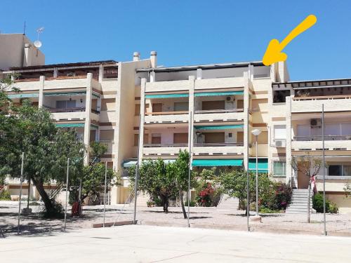 a building with a yellow arrow in front of it at ATICO CON VISTAS AL MAR EN LA AZOHIA in La Azohía
