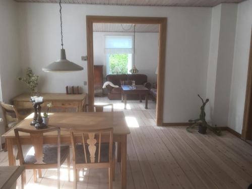 a living room with a table and a dining room at Herlebo in Tønder