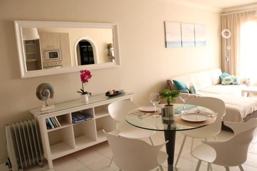 a living room with a table and chairs and a couch at CASA JABLILLO in Costa Teguise