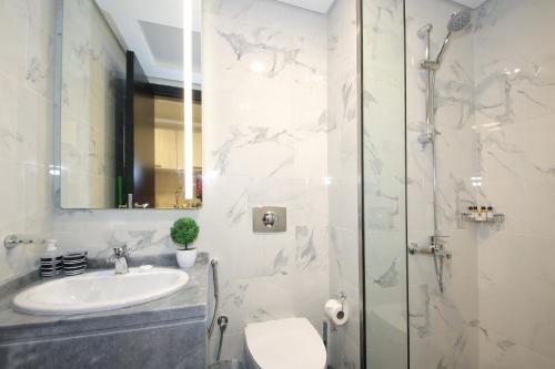a bathroom with a sink and a shower at SHH - Furnished Studio in MAG 5, Dubai South Near to Expo 2020 in Dubai