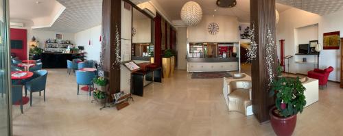 a living room with a restaurant with tables and chairs at Hotel K2 Bellaria in Bellaria-Igea Marina