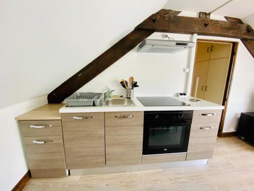 a kitchen with a sink and a stove at résidence les pâquerettes N 4 in Le Mont-Dore