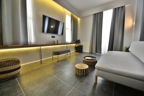a living room with a couch and a tv at Hydra Icons in Hydra