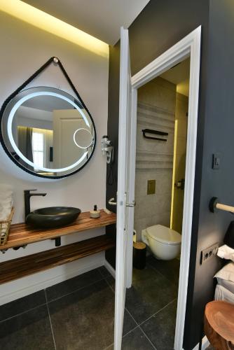 a bathroom with a sink and a mirror at Hydra Icons in Hydra