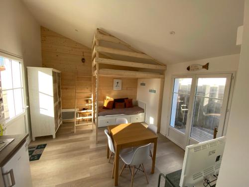 Kleines Zimmer mit einem Bett, einem Schreibtisch und einem Schlafzimmer. in der Unterkunft Appartements Les Homards du Fier #3 in La Guérinière