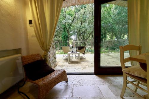 an open door to a patio with a table and chairs at Agriturismo Iazzo Scagno in Martina Franca