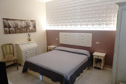 a small bedroom with a bed and a dresser and a bed sidx sidx sidx at Hotel Atlantico in Castiglioncello