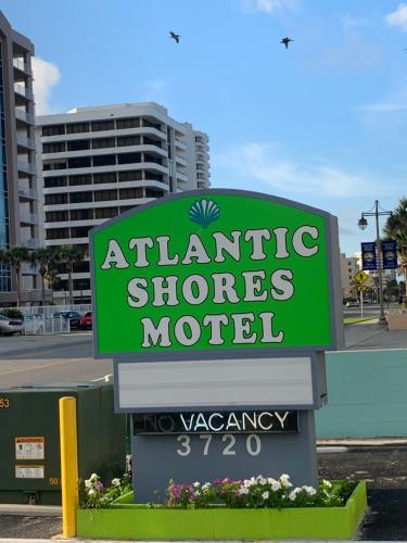 a sign for an atlantic shops motel at Atlantic Shores Motel in Daytona Beach
