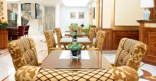 a dining room with a table and chairs at Hotel Marconi in Milan