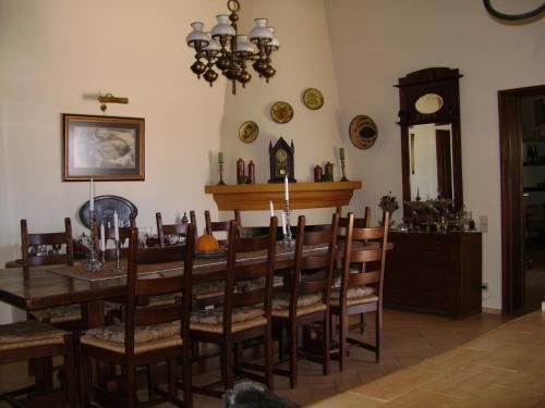 a dining room with a table and chairs and a clock at Quinta Do Cano in Évora