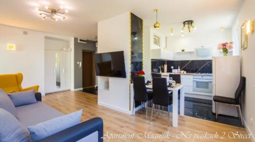 a living room with a couch and a kitchen at Bayside Apartments in Gdańsk
