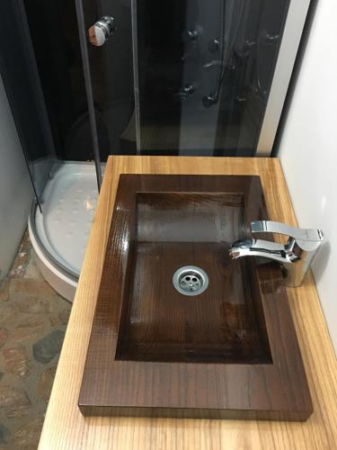 a bathroom with a wooden sink and a toilet at Wineyards Salin in Turda