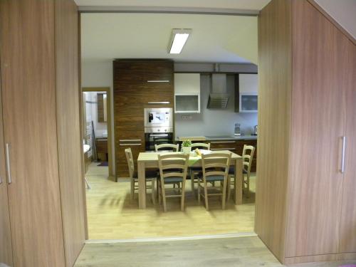 a kitchen and dining room with a table and chairs at Apartment WELLNESS Vlčková in Vlčková
