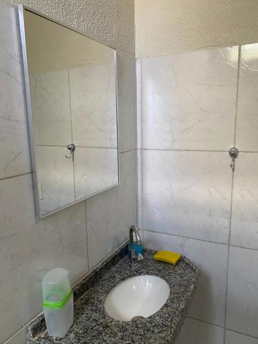 a bathroom with a sink and a mirror at Pousada da Celma in Fortaleza