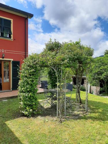 a garden with a table and trees in a yard at Il Vecchio Noce in Brugnato