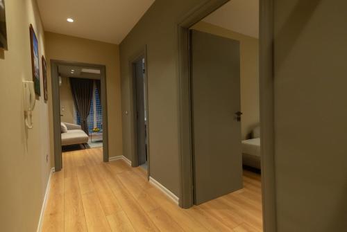 a hallway with a door open to a bedroom at Porta Apartament in Vlorë