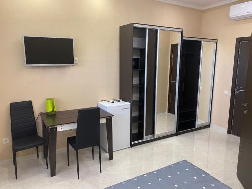 a room with a desk and a television on the wall at Міні-готель "Кімната Комфорт" in Odesa