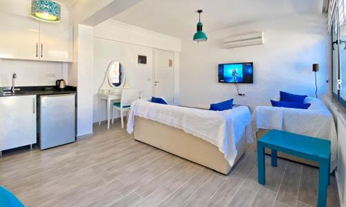 a living room with a couch and a kitchen at Nur Suites & Hotels in Kalkan