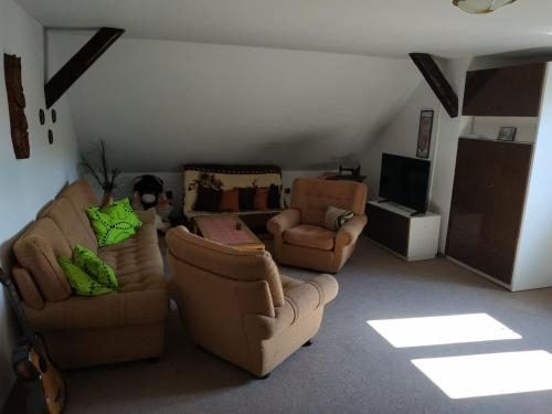 a living room with two couches and a tv at Ubytování na Šumavě in Sušice