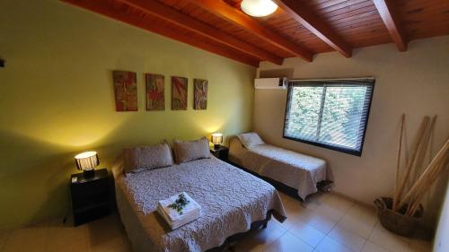 a bedroom with a bed and a window at Alta Morada in Villa Carlos Paz