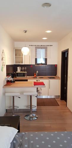 a kitchen with a table and a counter top at Apartments Barac in Poreč