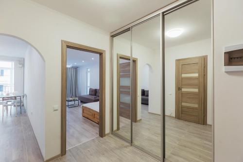 a room with sliding glass doors and a bedroom at DomkoLviv in Lviv