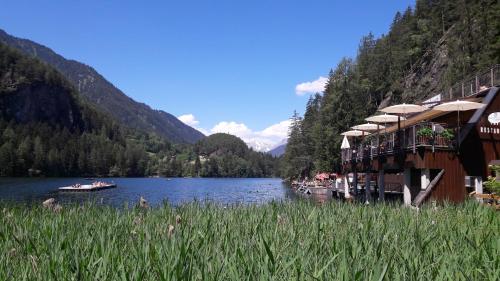 a resort on a river with boats in the water at Maridl`s Ferienhaus in Umhausen
