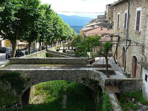 an old stone bridge over a street in a city at B&B La casa dei nonni in San Donato Val di Comino