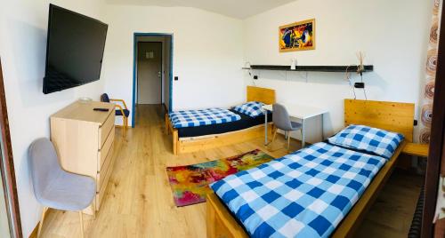 um quarto com 2 camas e uma televisão de ecrã plano em sleep24 - Monteur Zimmer In Eschelberg em Eschelberg