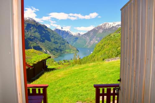 a view of a mountain lake from a window at Hole Hytter in Geiranger