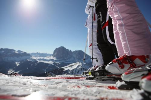 two skiers standing on top of a snow covered mountain at Alpine Chalet Sauter in San Vigilio Di Marebbe