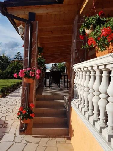 a staircase leading to a house with flowers on it at VILLA NIKOLINA in Medulin