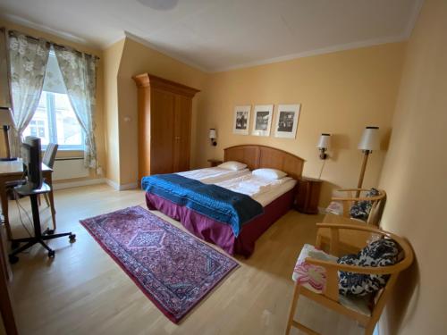 a bedroom with a bed and a television in it at Broby Gästgivaregård in Sunne