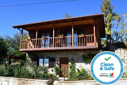 a house with a balcony and a sign in front of it at Casa de Sao Joao in Gandarela