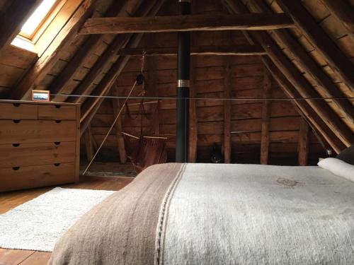 a bedroom with a bed in a attic at CABAÑA VENTO NORTE in Vilamós