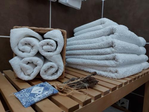 a bunch of towels are sitting on a shelf at Santa Luzia Apartment in Santa Luzia