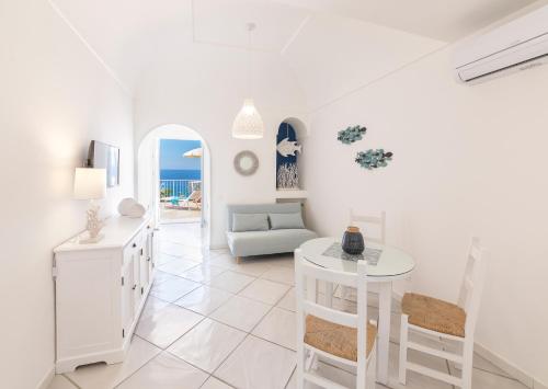 a living room with a table and a couch at Villa dei Lecci - 7 Luxury villas with private pool or jacuzzi in Ischia
