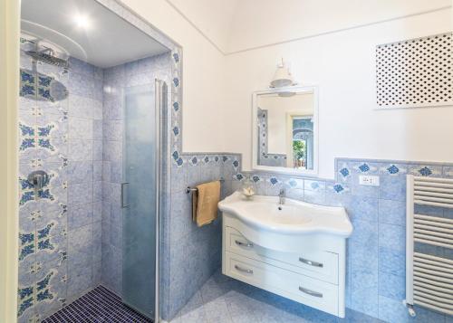a bathroom with a sink and a shower at Villa dei Lecci - 7 Luxury villas with private pool or jacuzzi in Ischia